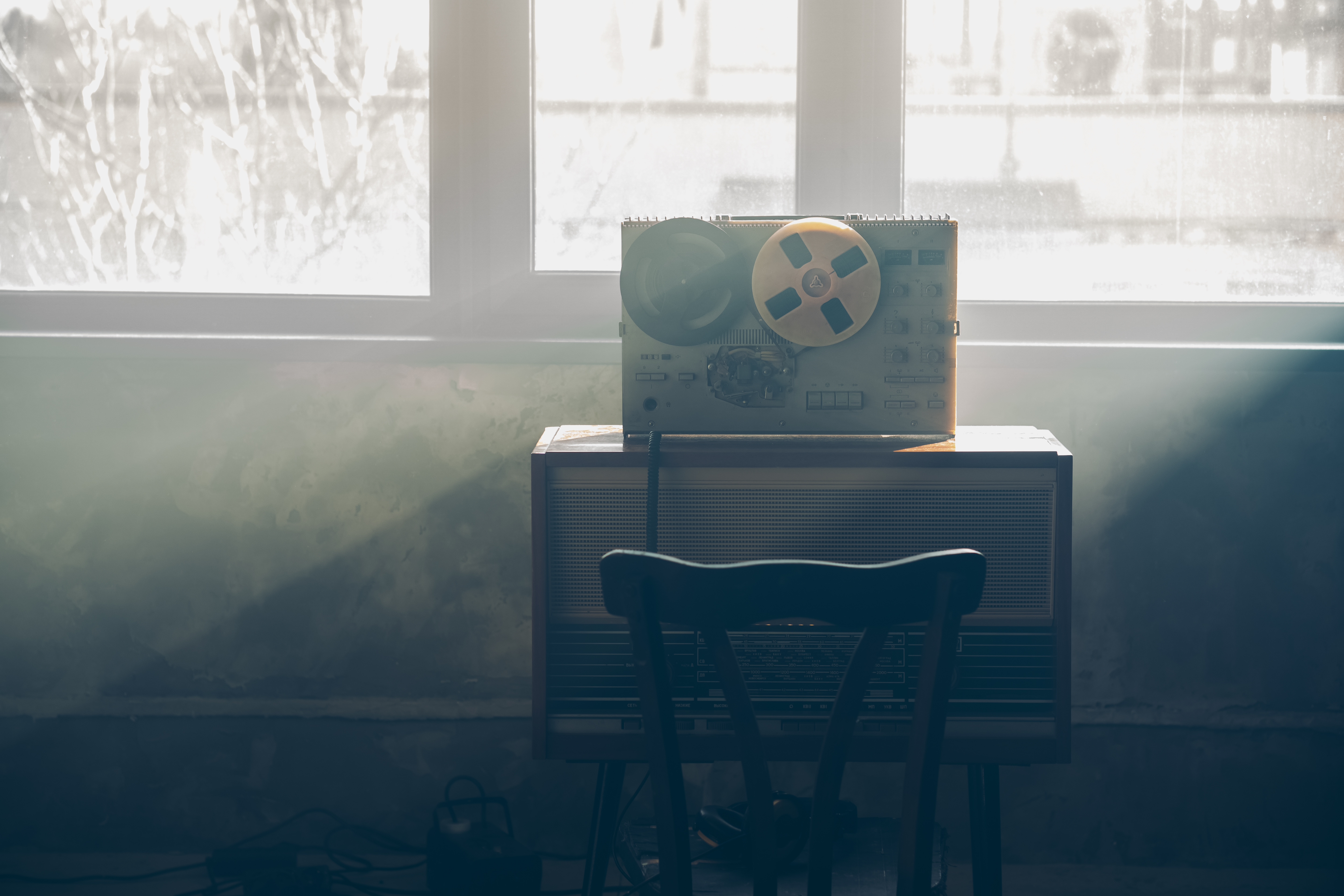 Wiretapping on the reel tape recorder. Headphones near the technique. Special agent work. Retro old school spying on conversations. Picture is from Adobe Stock.